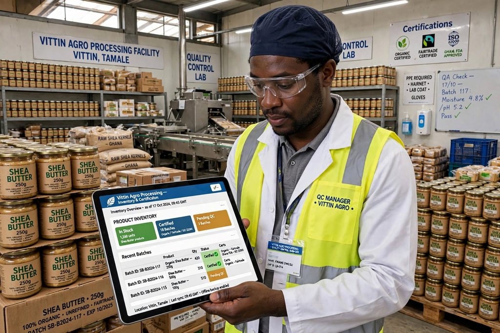 industrial worker in a high-visibility vest and cap reviews an inventory tablet amid jars of shea butter in a processing facility.